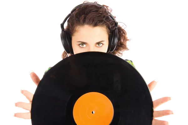 Красиві молоді усміхнені жінки DJ слухають музику в навушниках і тримають вінілову пластину — стокове фото