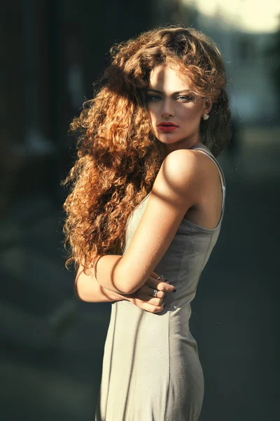 Summer portrait of a beautiful young Caucasian girl with curly hair — Stock Photo, Image