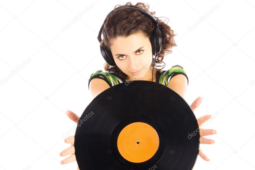 Beautiful young smiling women DJ listening music in headphones and holding vinyl plate