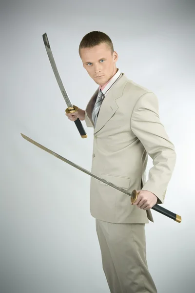 stock image Studio portrait of a young handsome businessman holding a samura