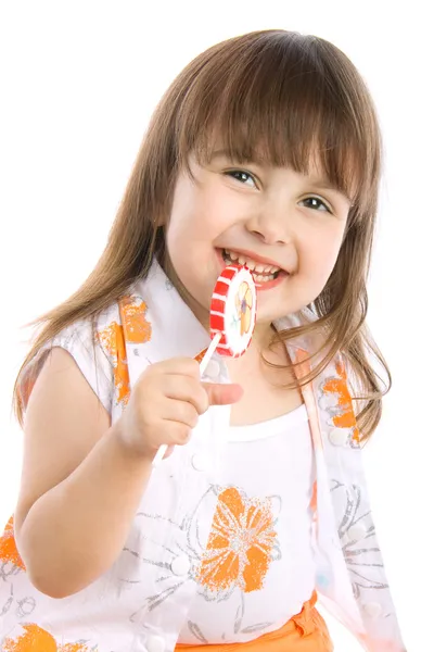 Entzückendes kleines Mädchen mit einem Bonbon — Stockfoto