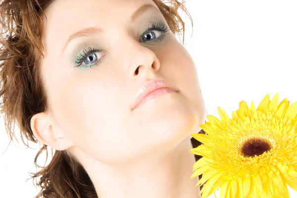 Closeup studio portrait of a beautiful young woman with yellow flower — Stock Photo, Image