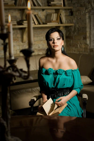 Beautiful young brunette woman reading a book. Retro stylization — Stock Photo, Image