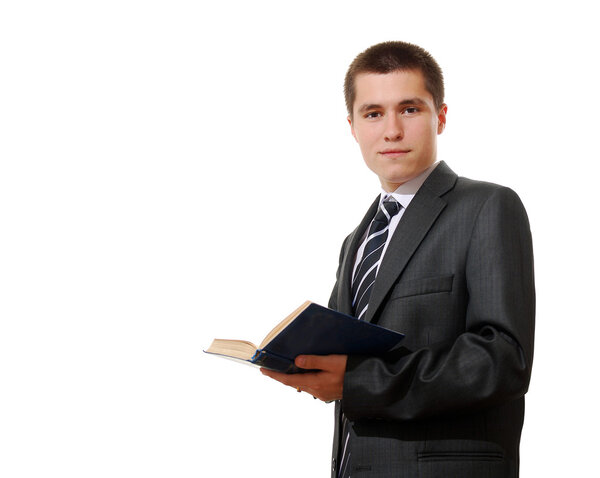 Young businessman in a suit reading a book
