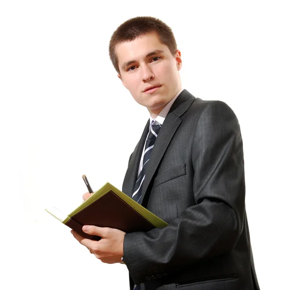 Business man with a book and pen, looking into the camera — Stock Photo, Image