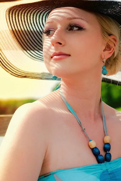 Portrait of pretty cheerful woman wearing white dress and straw hat in sunny warm weather day — Stock Photo, Image