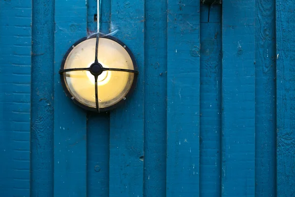 Lamp on a blue wall — Stock Photo, Image