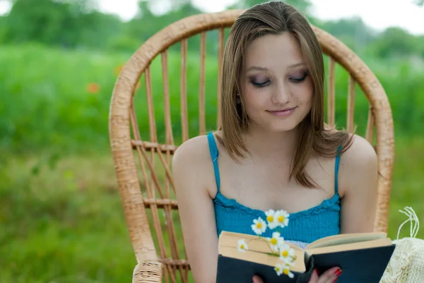 Joven hermosa mujer descansando en el jardín con libro —  Fotos de Stock