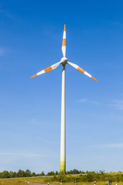 stock image Windmill gathers energy from the summer breeze.