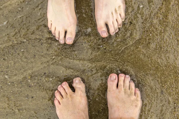Feet of father and son at the beach — Stock Photo, Image