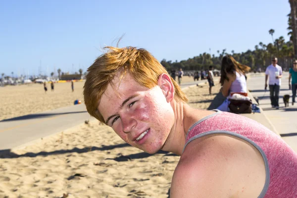 Lächelnder attraktiver Junge posiert am Strand — Stockfoto