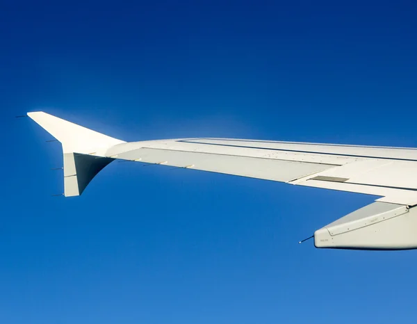 Aircraft wing some component of plane on during flying high abov — Stock Photo, Image