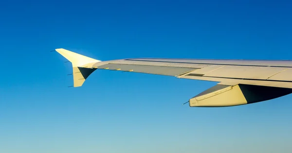 Aircraft wing some component of plane on during flying high abov — Stock Photo, Image