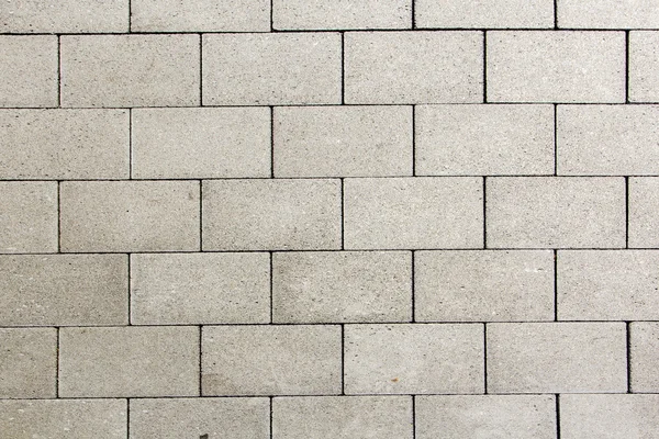 Detalhe de azulejos na rua dá um padrão harmônico — Fotografia de Stock
