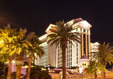 Caesars Palace resort facade by night clipart