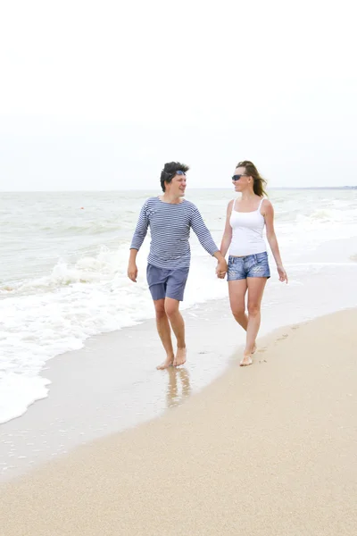 stock image Happy young couple enjoying together at the beach