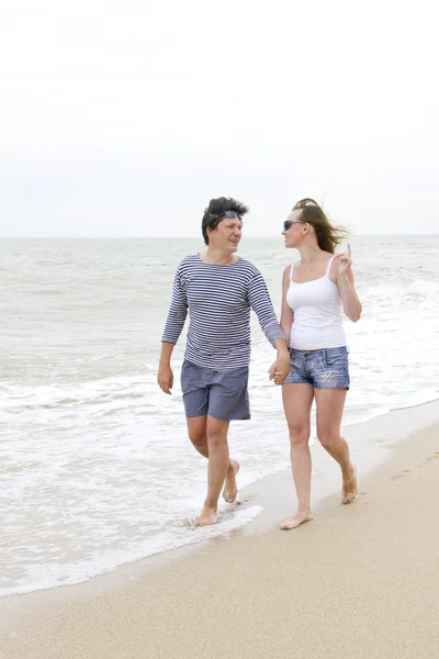 stock image Happy couple enjoying together at the beach