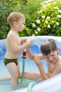 Two boys in the swimming pool clipart