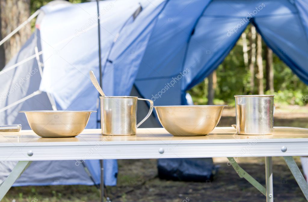 Tourist utensils near camping tent