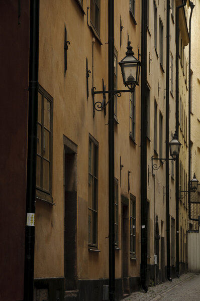 Antique buildings in a dark and narrow alley in Stockholm old town (Gamla stan), Sweden