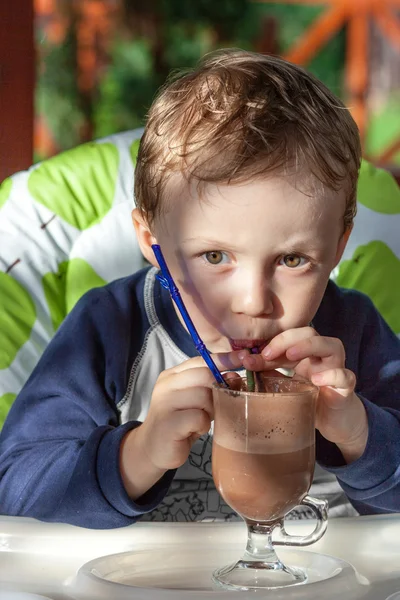 Kid drinking a chocolate cocktail — Stock Photo, Image