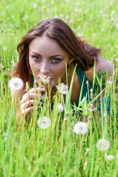 Beautiful woman with dandelions — Stock Photo, Image