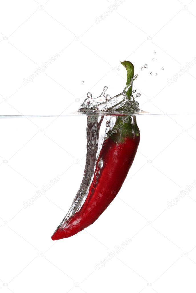 Falling red pepper in water
