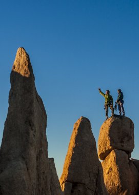 Climbing team struggles to the summit. clipart