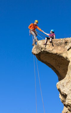 Climbing team struggles to the summit. clipart