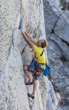 Climber gripping the rock. clipart