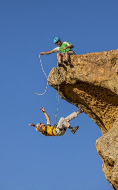 Falling climber saved by his partner. clipart