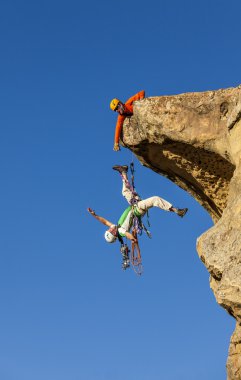 Climbing team struggles to the summit. clipart