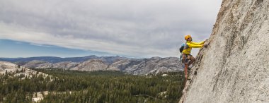 Rock climber on the edge. clipart