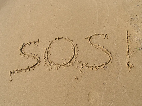 Stock image Inscription SOS on a sandy beach