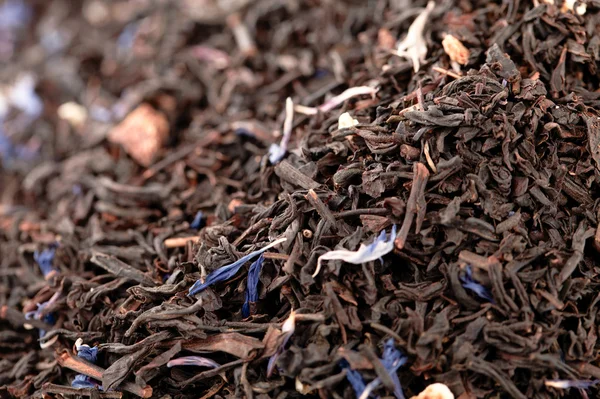 Dame grijs zwart losse thee bladeren achtergrond, ondiep dof — Stockfoto