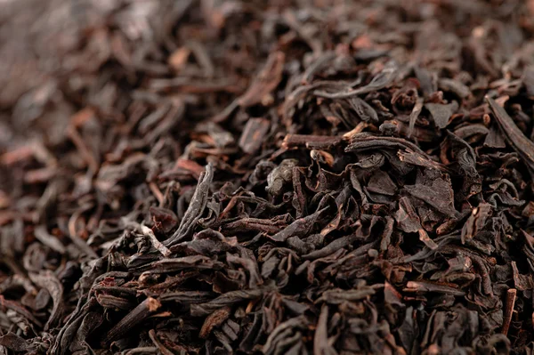 stock image Earl Grey black loose tea leaves background, shallow dof
