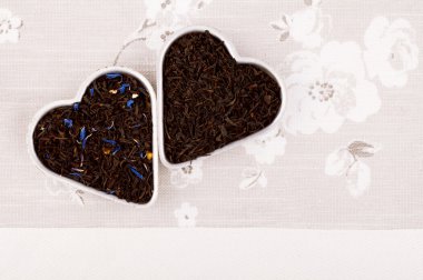 Earl Grey and Lady Grey black loose tea leaves in heart shape,on clipart