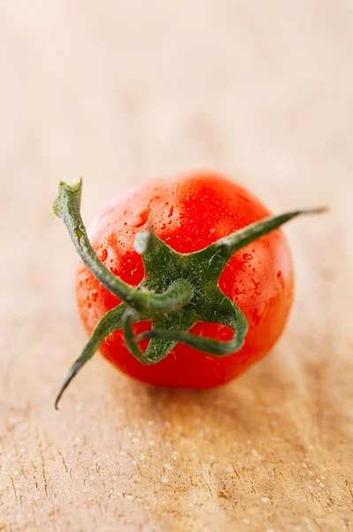 Cherry tomato on wooden backdrop , shallow DOF — Stock Photo, Image