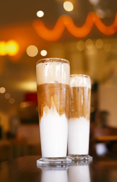 Buzlu kahve latte ile arka planda uzun boylu gözlük ışıkları — Stok fotoğraf