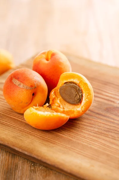 Fresh apricots on wooden table — Stock Photo, Image