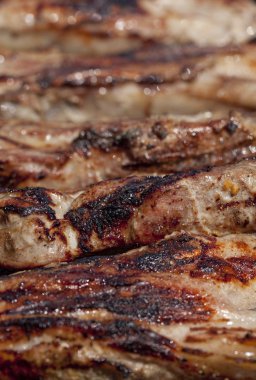 Seasoned pork chops ribs on a bbq clipart