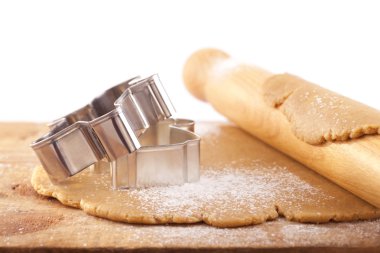 Christmas gingerbread cookie cutters on dough with rolling pin, clipart