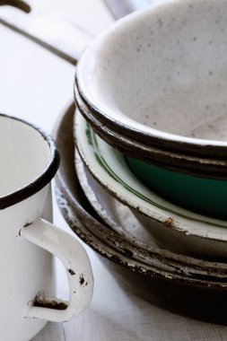 Assorted enameled plates pans and a mug very old clipart