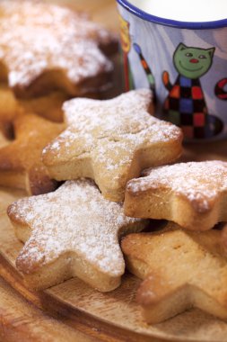 Homemade gingerbread star cookies with kids milk on wooden tab clipart