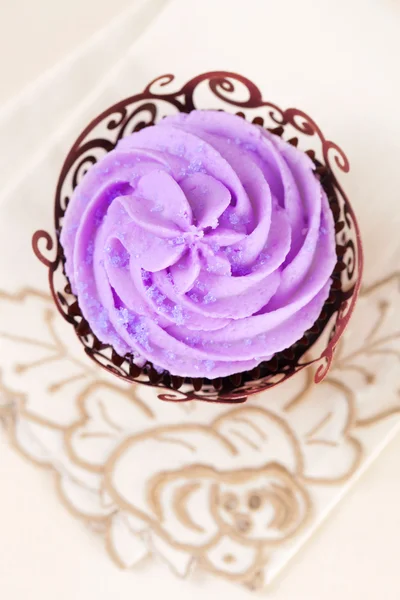Cupcake with lavender top in festive wrap on beige