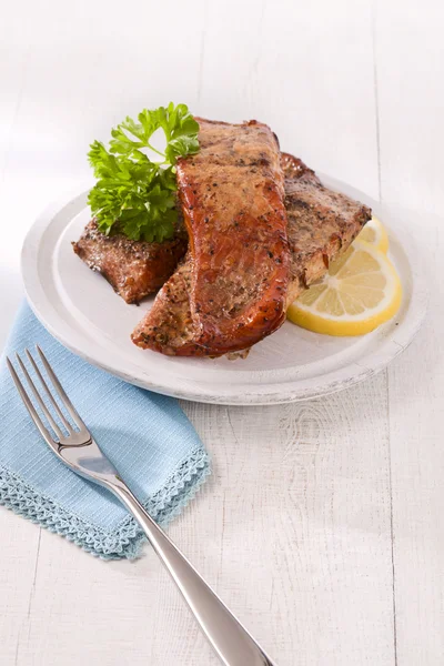 stock image Homemade hot smoked slamon fillet, on white wood with fork, pars