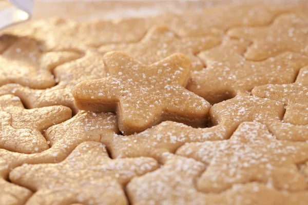 Gingerbread star cookie cuts dough, shallow dof, full frame — Stock Photo, Image