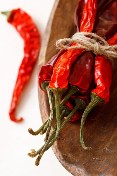 Red hot chillies pepper bunch in wooden bow — Stock Photo, Image