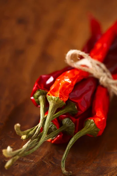 Red hot chillies pepper bunch in wooden bowl background — Stock Photo, Image