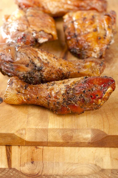 Homemade smoked chicken drumstick on wood, shallow DOF — Stock Photo, Image